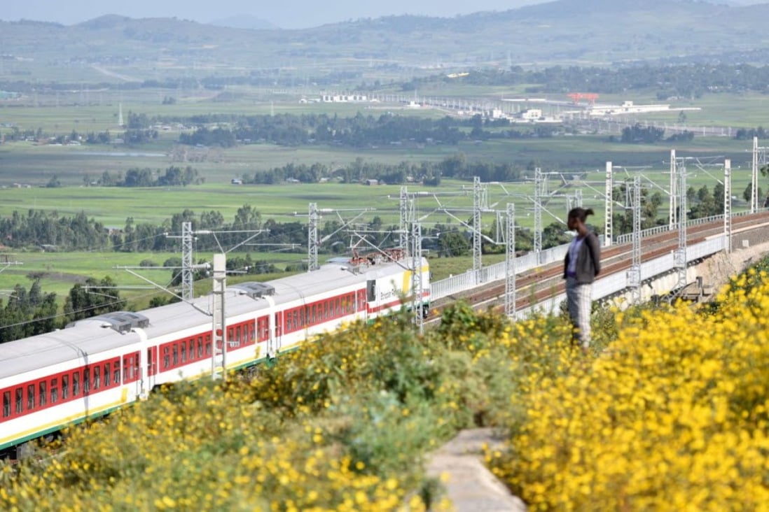 A person watches a train on the Ethiopia-Djibouti railway, Africa's first modern electrified railway, during an operational test near Addis Ababa, Ethiopia, on October 3, 2016. It was built by Chinese firms. Photo: Xinhua