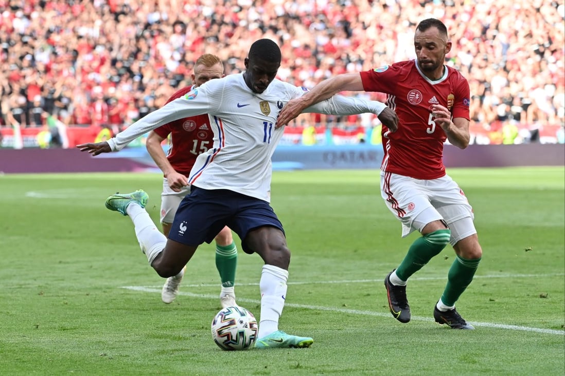 France’s Ousmane Dembele in action with Hungary’s Attila Fiola Pool at the Puskas Arena in Budapest during a Euro 2020 match on June 19. The rapid roll-out of the vaccine programme in Hungary meant that the stadium could host fans at full capacity. Photo: Reuters