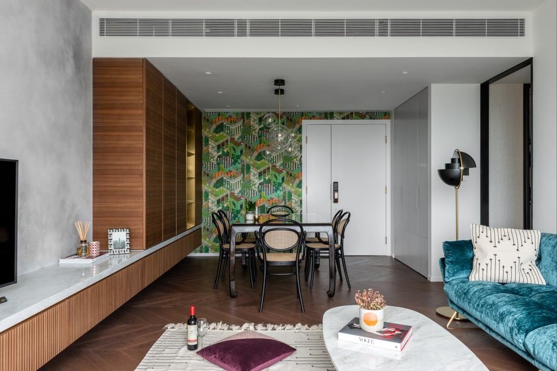 In the living room of this 1,600 sq ft flat in Sai King, custom-made American walnut cabinets run alongside a teak dining table that the owner inherited from his late father. Photography: Hoo