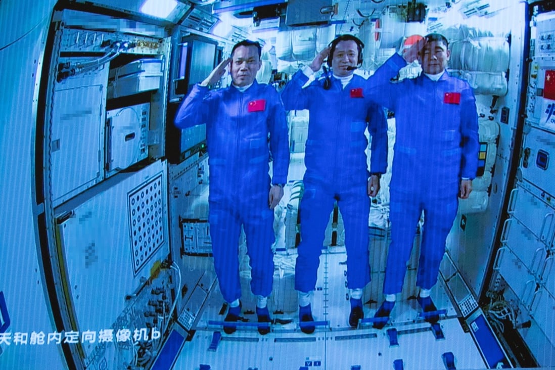 Three Chinese astronauts onboard the Shenzhou-12 spaceship salute after entering the Tianhe space station core module on June 17, 2021. Photo: EPA-EFE