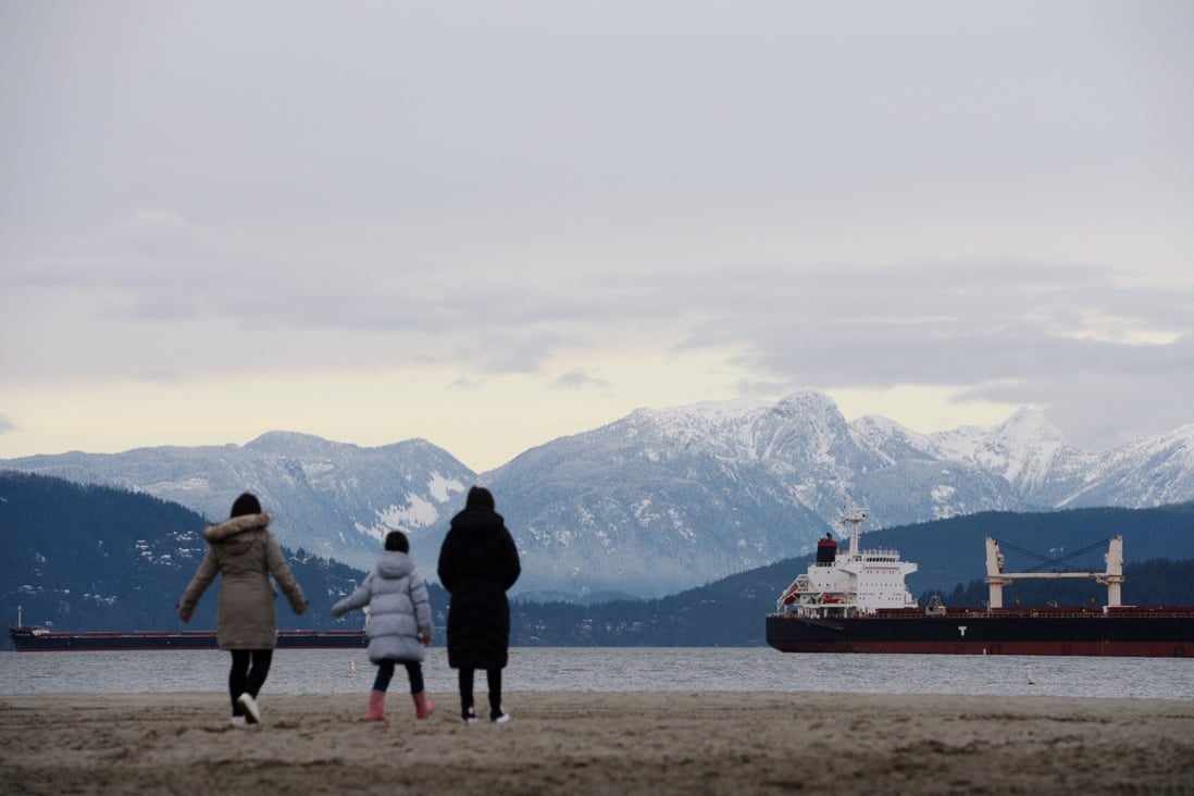 A family of Hong Kong immigrants walks along Jericho Beach in Vancouver, British Columbia, on January 26. Photo: Reuters