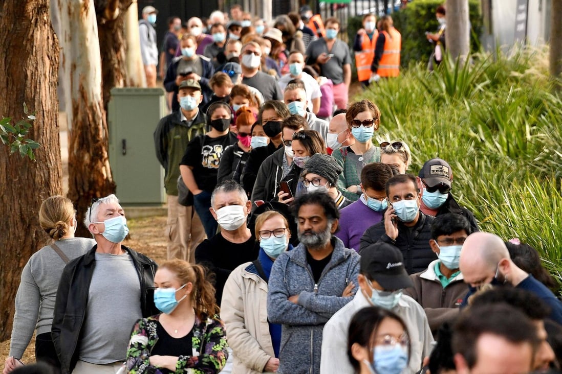 People queue outside a vaccination centre in Sydney on June 24 as residents were largely banned from leaving the city to stop a growing outbreak of the highly contagious Covid-19 Delta variant spreading to other regions. Photo: AFP