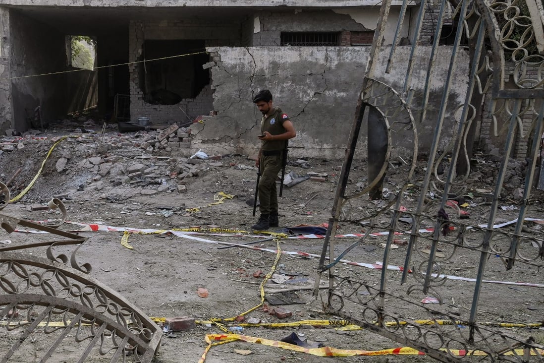 A policeman inspects the site of the June 23 car bomb that killed three people in Lahore. Photo: AFP