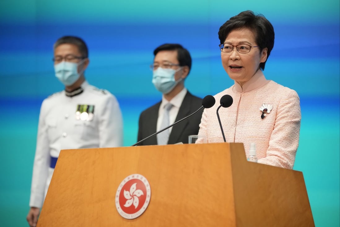 Hong Kong’s Chief Executive Carrie Lam speaks as new Chief Secretary John Lee, centre, and new Commissioner of Police Raymond Siu Chak-yee look on, during a news conference in Hong Kong on June 25. Photo: AP  