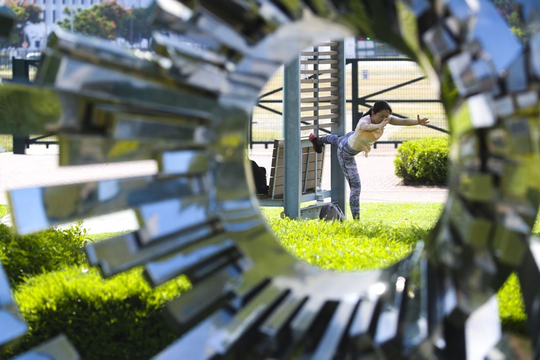 A woman goes through her exercise routine at Tamar Park. Photo: Edmond So