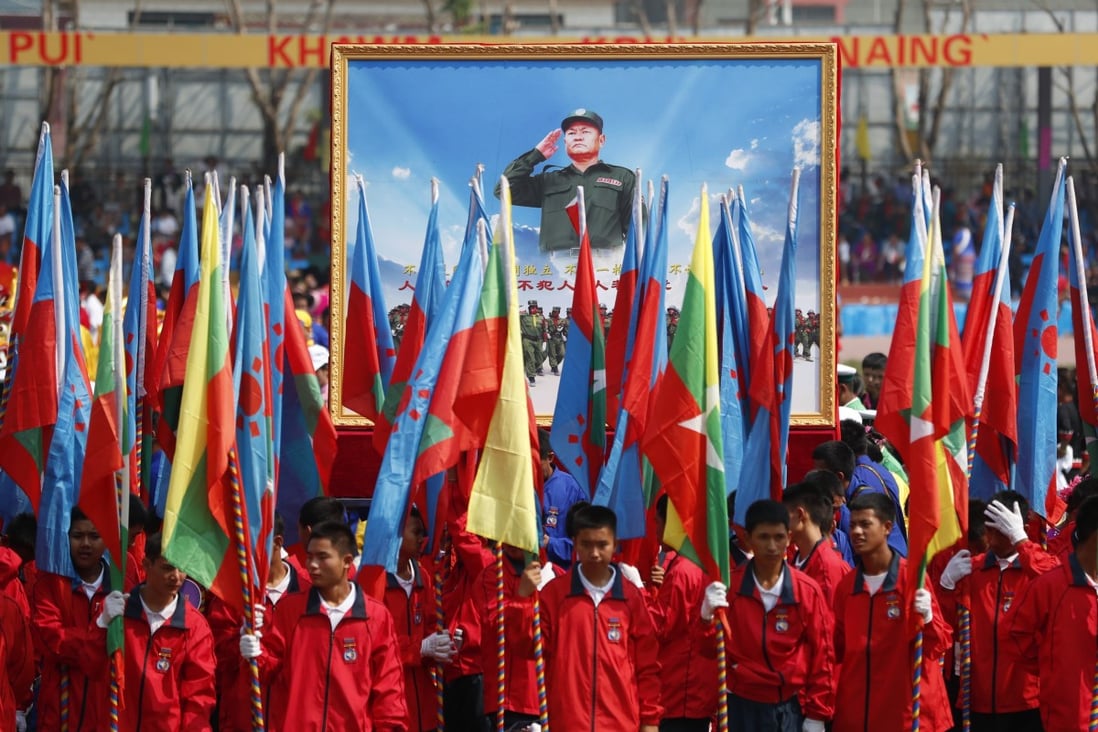 People hold a portrait of Wa State’s leader Bao Youxiang during a ceremony to mark the 30th anniversary of Wa State on April 17, 2019. Photo: EPA-EFE