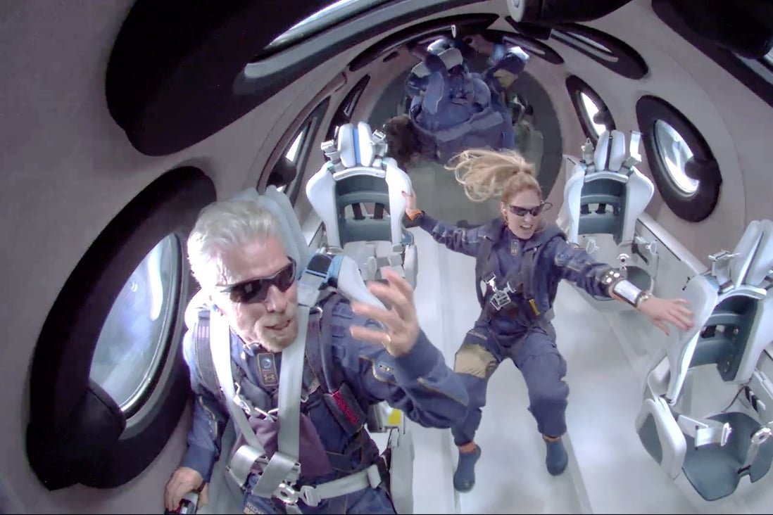 Sir Richard Branson (left) and other crew members attain zero gravity during their Virgin Galactic space flight. Photo: EPA-EFE