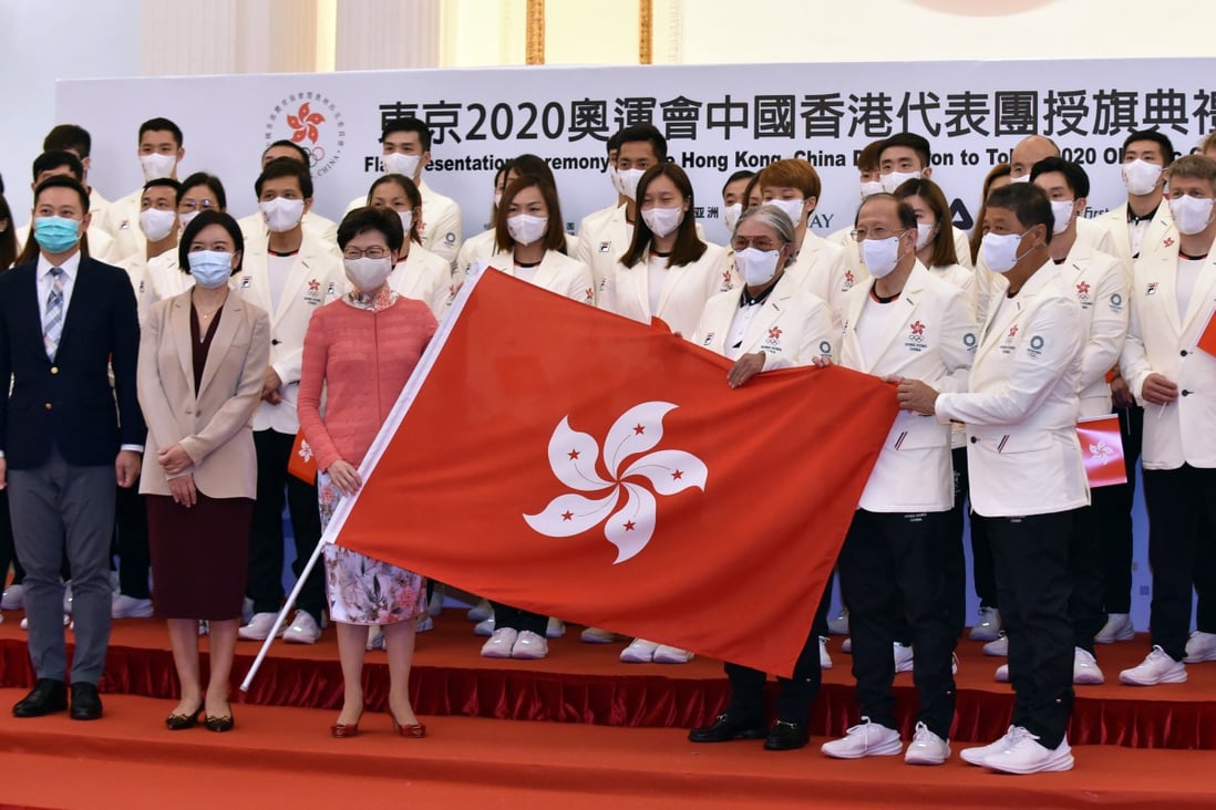Hong Kong’s Chief Executive Carrie Lam Cheng Yuet-ngor (in pink blouse, first row) and sports chief Timothy Fok Tsun-ting (first row, third right)  pose with members of the Hong Kong delegation during a flag presentation ceremony for the Tokyo Olympic Games, at Government House on July 8. Photo: Xinhua 