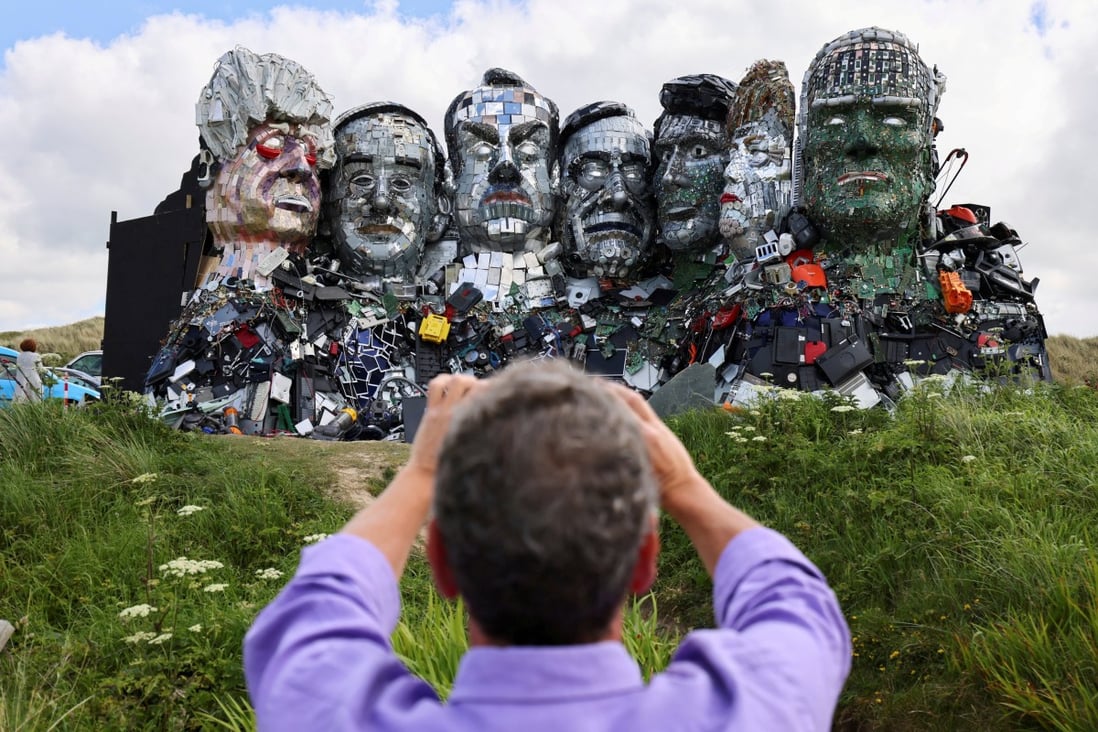 A man photographs ‘Mount Recyclemore’, an artwork made from electronic waste by Joe Rush and Alex Wreckage, ahead of the Group of 7 summit in Cornwall, England, on June 8. Photo: Reuters