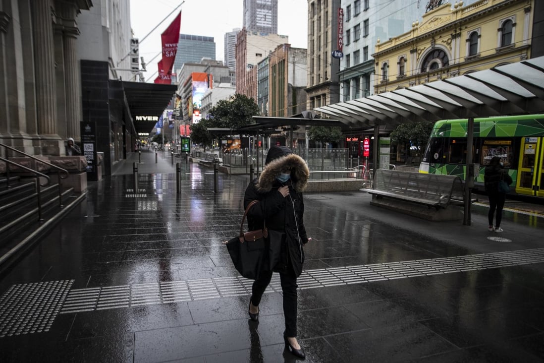 A woman walks along Bourke Street mall in Melbourne, Victoria,  on July 20, days after the Australian state entered a lockdown in response to a surge in Covid-19 cases. Photo: EPA-EFE