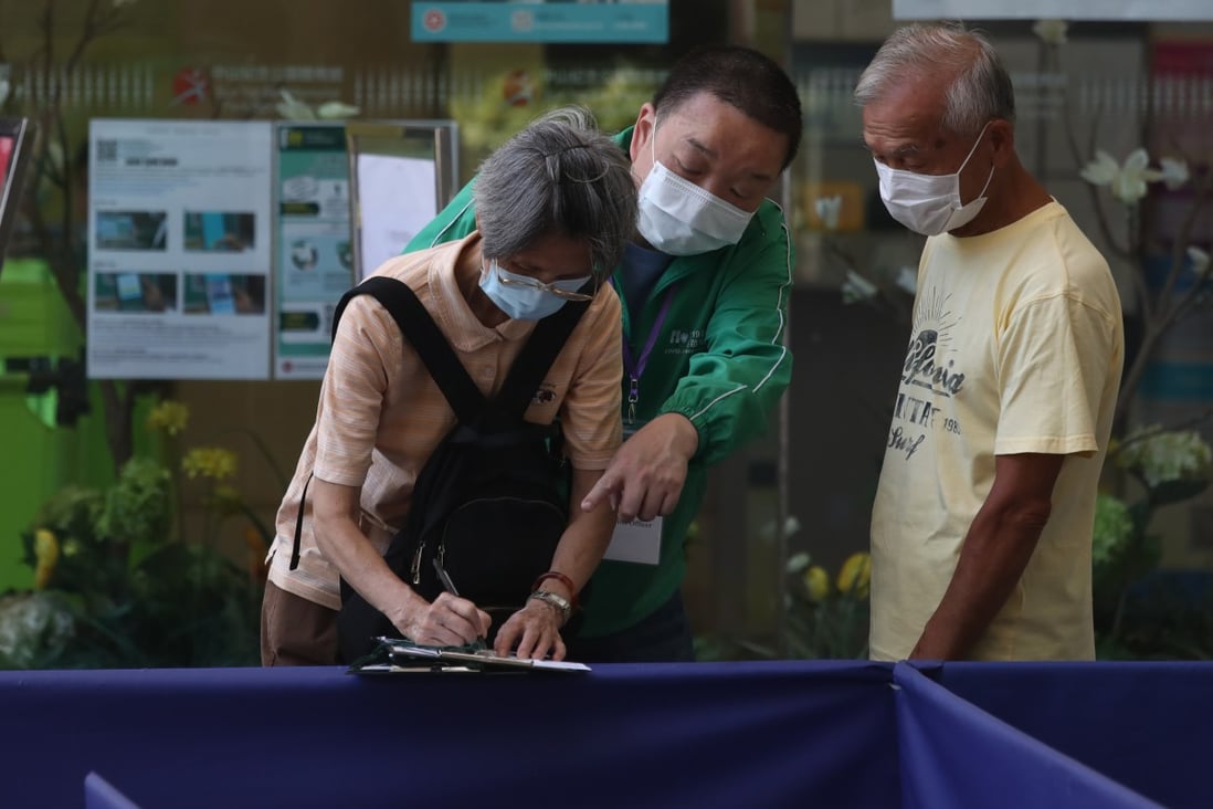 Elderly people fill in a form outside a Covid-19 vaccination centre in Sai Ying Pun on July 12. Photo: Jonathan Wong