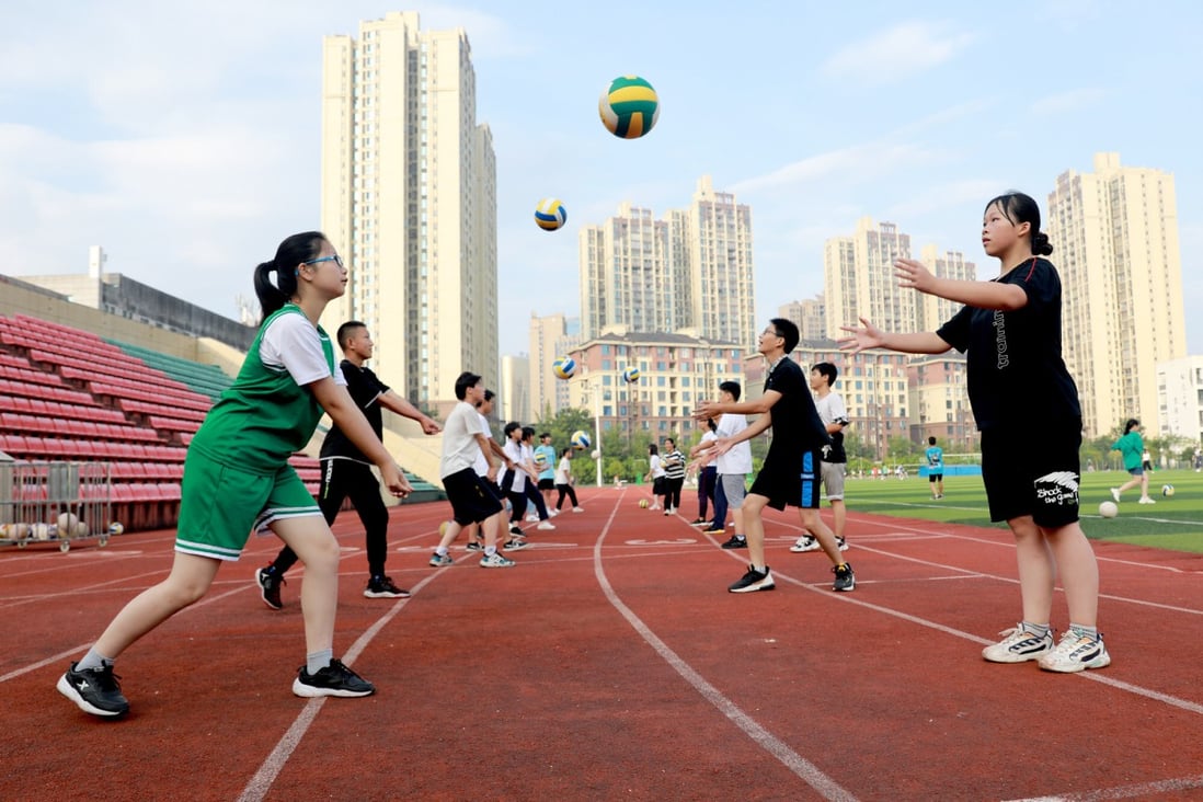 Students play volleyball during a summer programme in Huaying city, Sichuan province. Low fertility rates have made reducing the cost of raising children a priority for Beijing, in the interest of China’s long-term development. Photo: Xinhua