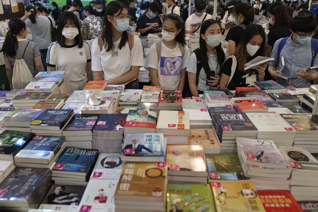 People browse at a booth during the annual Hong Kong Book Fair on July 17. International meetings, conferences and exhibitions brought 2.3 million visitors to Hong Kong in 2018. Photo: AP