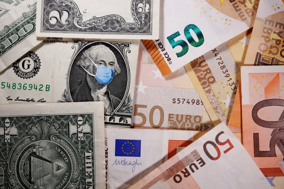 A masked George Washington on a US dollar note next to euro banknotes. Carry trades, which have been dormant since the global financial crisis, are set to come back in a big way. Photo: Reuters