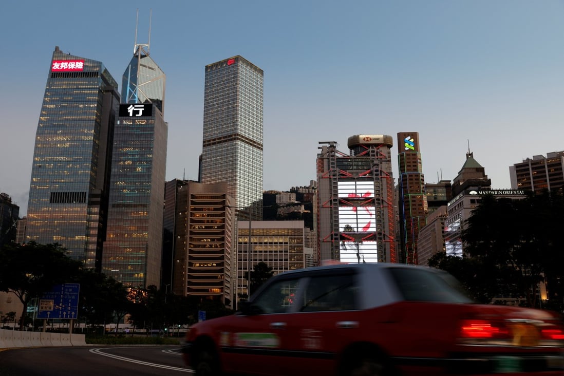 A taxi drives in front of skyscrapers in the central business district in Hong Kong on August 17. The rise of indirect investment in Asian property is a short-term, Covid-19-induced aberration, not a long-term trend. Photo: Reuters 