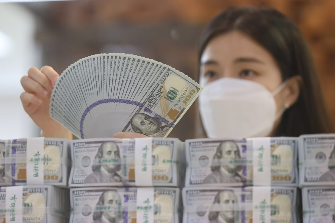 A clerk checks US$100 banknotes at the headquarters of Hana Bank in Seoul, South Korea, on July 5. Currency markets will price the US dollar based on what Washington does, not what it says. Photo: EPA-EFE
