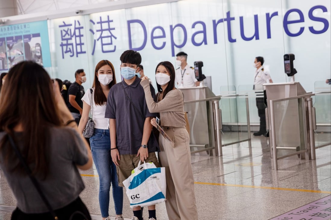 Friends and relatives take photos before boarding a London-bound flight at Hong Kong airport on August 8. Photo: EPA-EFE