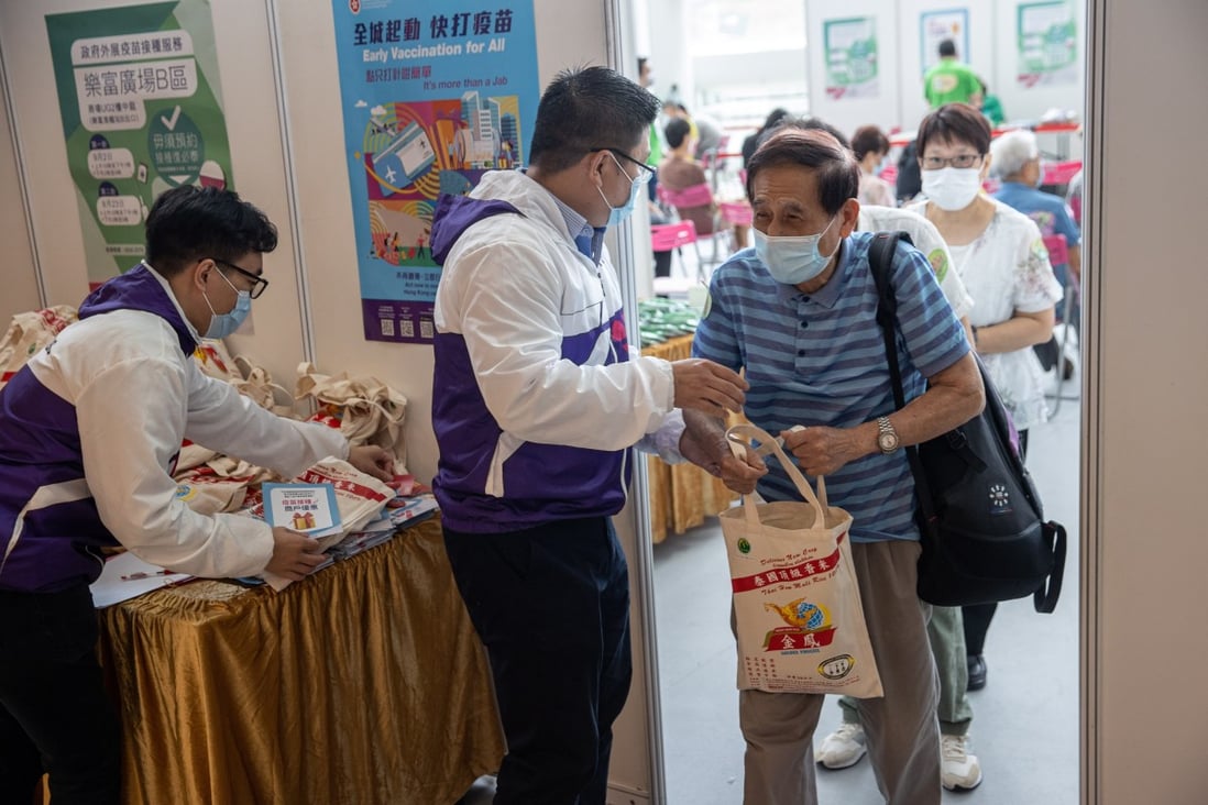 A man receives a free bag of rice after getting a Covid-19 vaccine shot at a shopping mall in Hong Kong on September 2. The Link Reit, which owns the shopping centre, organised the initiative with the government to boost vaccination rates in the city. Photo: EPA-EFE