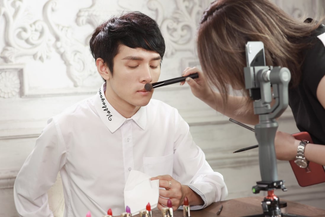 Popular Chinese beauty blogger Austin Li Jiaqi has make-up applied as he prepares for a livestream.Photo: VCG via Getty Images