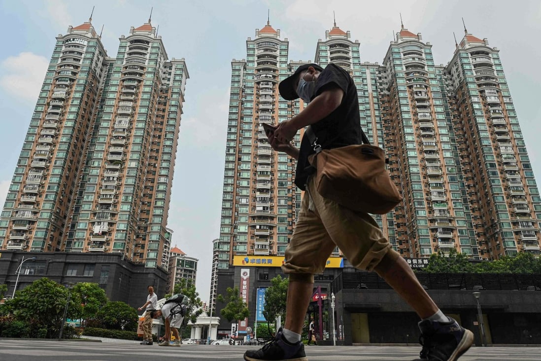 A man walks past a housing complex by Chinese property developer Evergrande in Guangzhou on September 17. The current problems in China’s real estate sector have only added to the pressure on Chinese equities. Photo: AFP