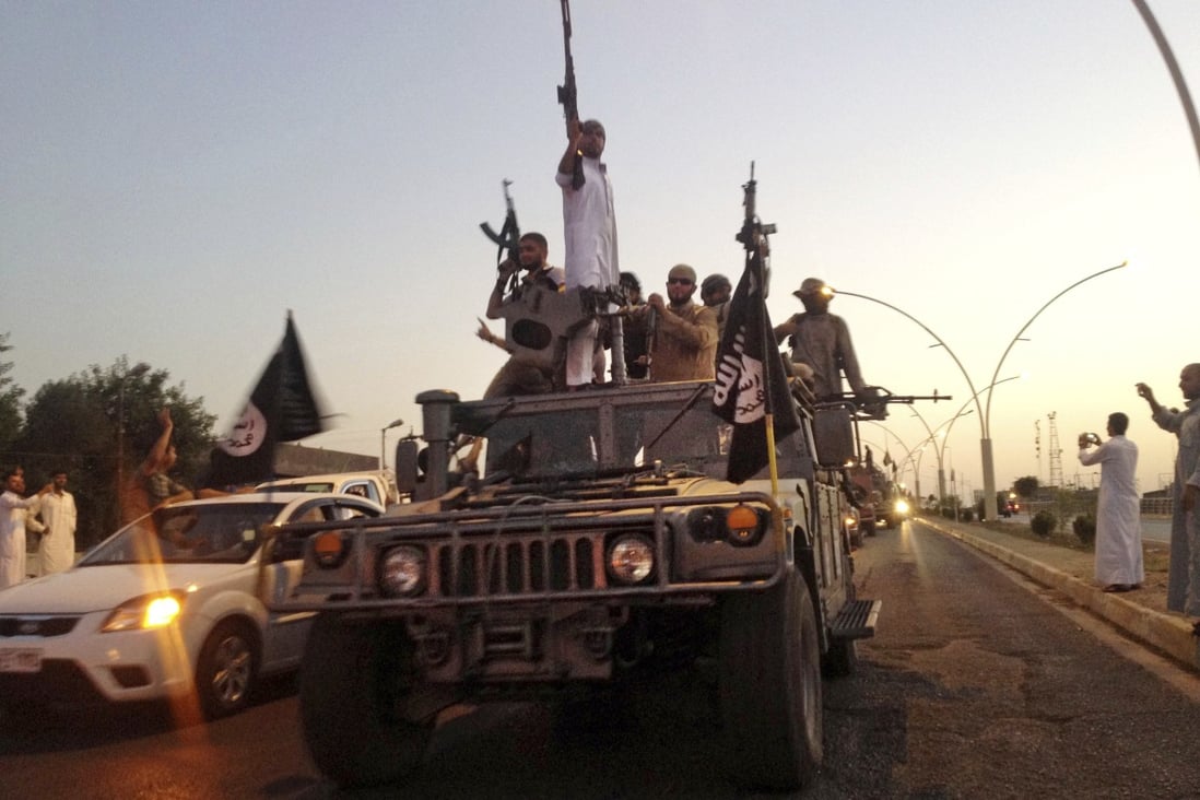 Isis fighters parade in a commandeered Iraqi security forces armored vehicle in 2014. Groups linked to Isis and al-Qaeda are seen as among the most serious terror threats in Southeast Asia. Photo: AP