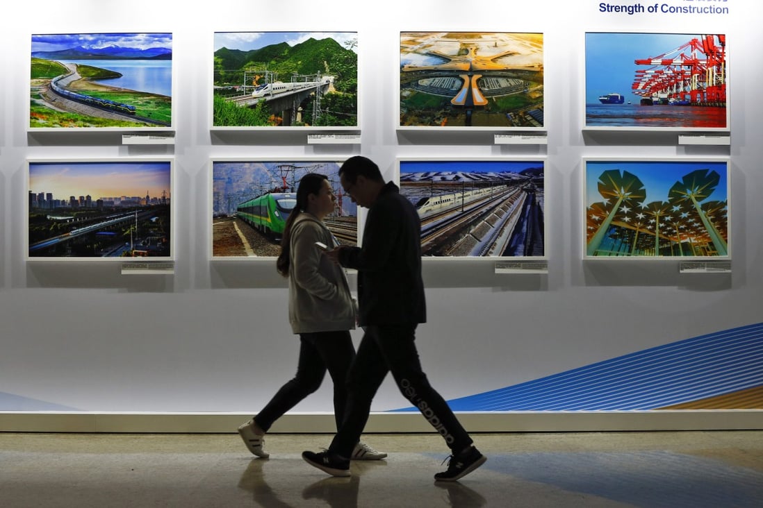 People walk by a display board showcasing China’s construction projects, at the Belt and Road Forum in Beijing on April 27, 2019. Corruption has been a problem in some Belt and Road economies across Central Asia.
Photo: AP 