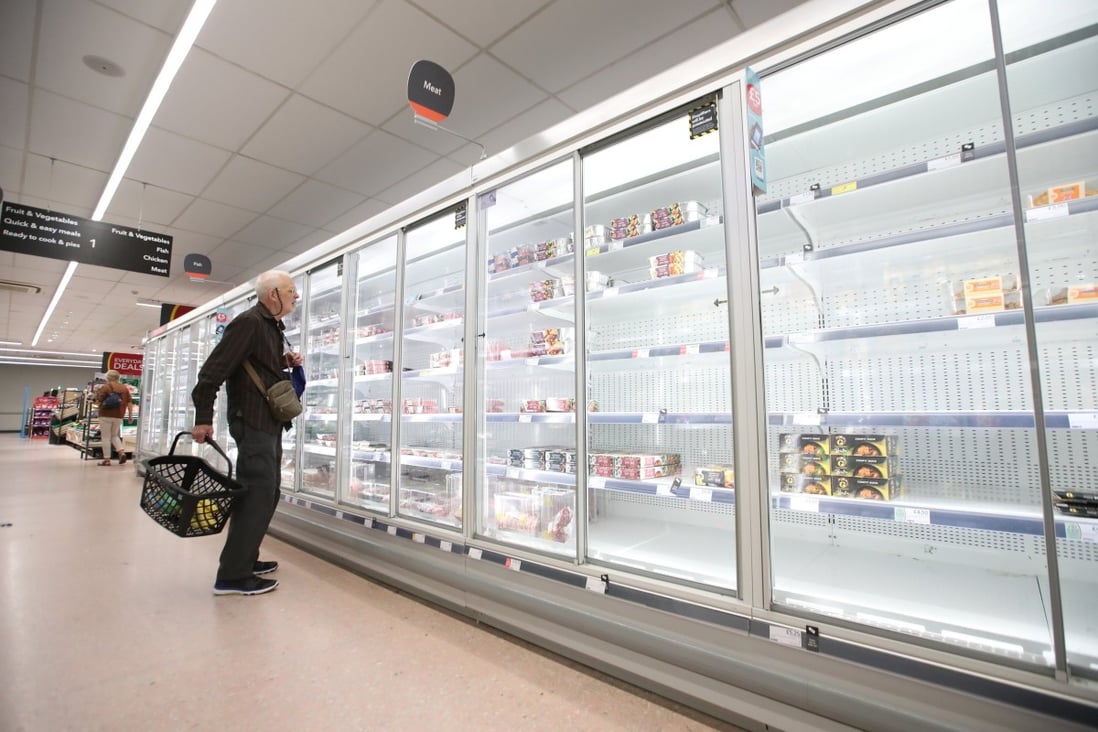 A customer surveys empty shelves in a Co-op supermarket in Harpenden, Britain, on September 22, amid a shortage of delivery drivers. Global supply chain constraints are making it difficult for manufacturers to meet their orders and pushing up costs. Photo: Reuters