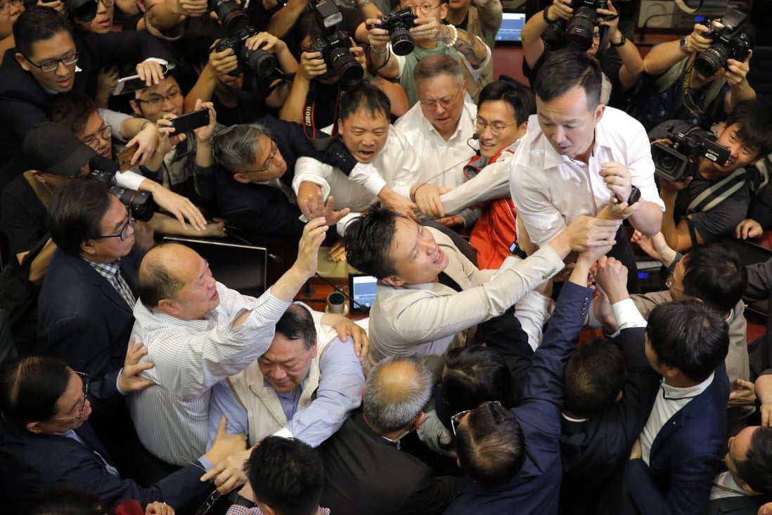 Pro-democracy and pro-government lawmakers scuffle over access to the Legislative Council chamber on May 11, 2019, amid a broader clash over controversial amendments to Hong Kong’s extradition laws. Photo: AP