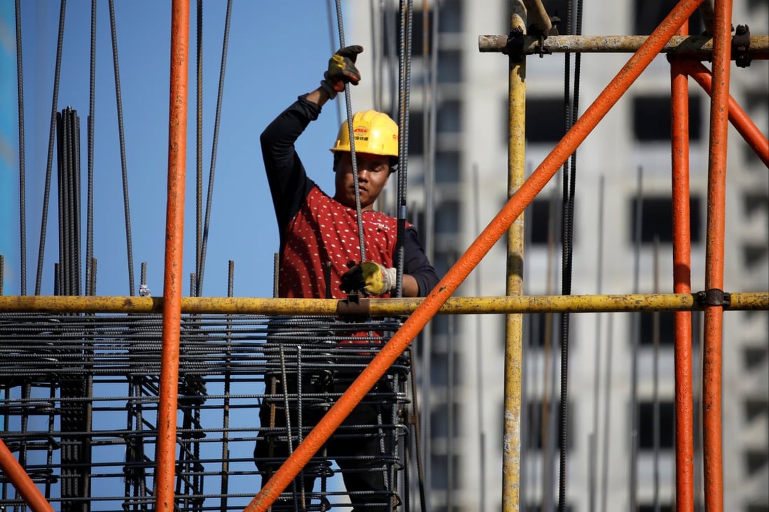 A man works on scaffolding at a construction site of a residential compound in Beijing on October 19, 2020. After an impressive rebound following the first wave of Covid-19, housing sales have weakened. Photo: Reuters