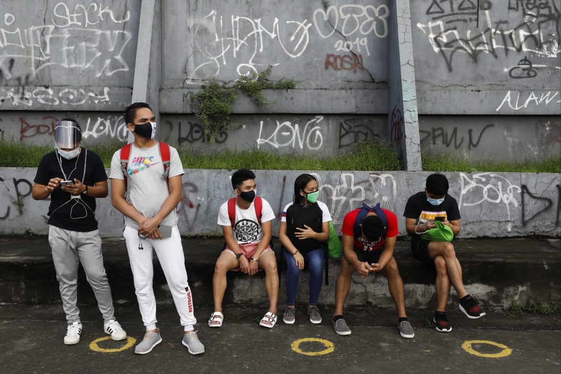 Young people wait for a ride at a public transport stop in Quezon City, the Philippines, on November 10, 2020. Youth unemployment in the country hit 22 per cent last year. Photo: EPA-EFE