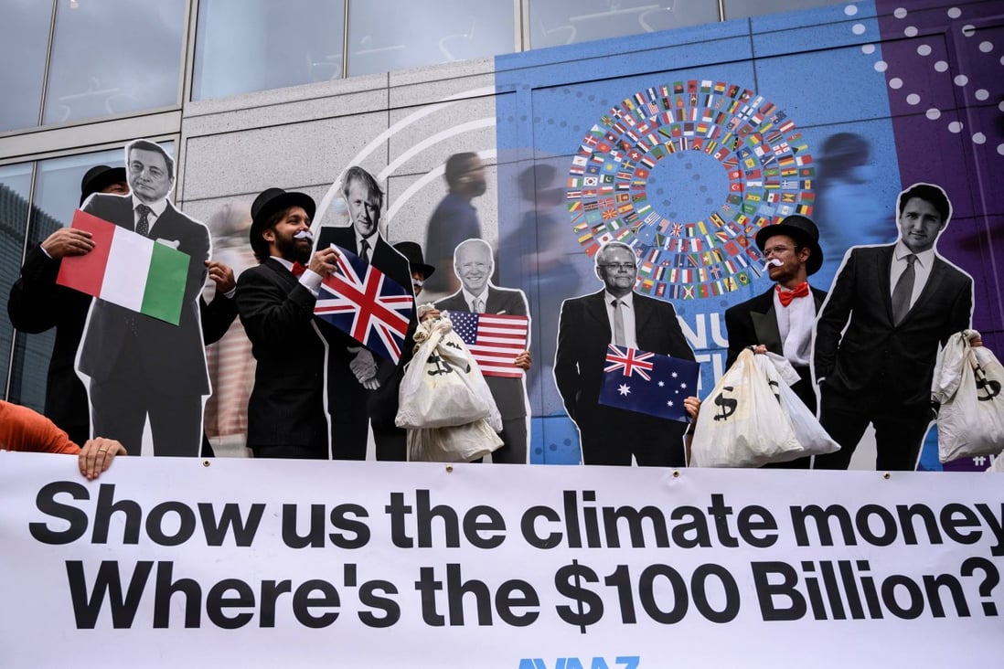 Activists dressed as debt collectors hold cutouts of world leaders during a demonstration at the International Monetary Fund headquarters to ask rich nations to keep their commitment to support developing countries in tackling climate change, in Washington on October 13. Photo: AFP