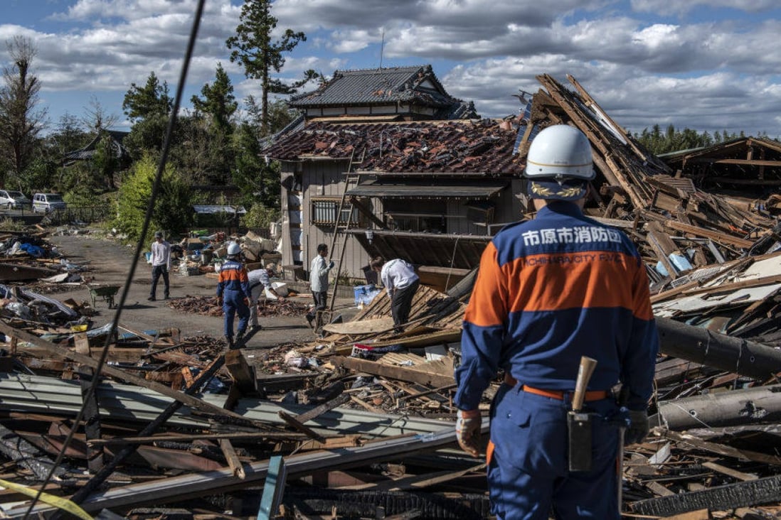 Search and rescue crews sort through the debris of a building in Chiba, Japan, destroyed by a tornado in 2019 shortly before the arrival of Typhoon Hagibis, one of the most powerful storms in decades to strike the country. Photo by Carl Court/Getty Images