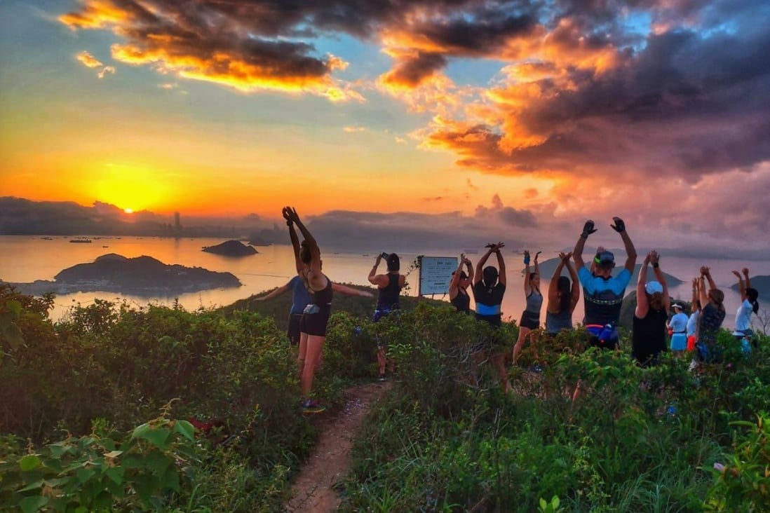 Members of the Lantau Sunrise Club take part in a movement exercise at sunrise on Lantau Island, Hong Kong. The group meets weekly for breathwork meditation and exercises. Photo: Novy Lodder