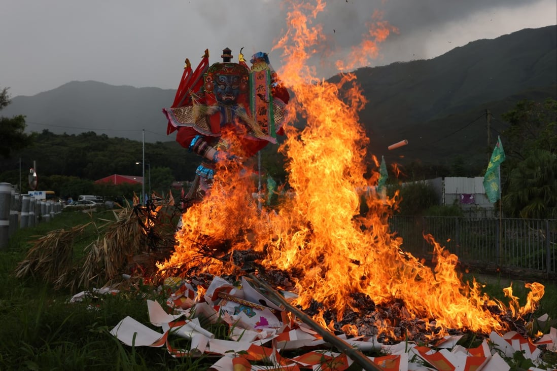 A huge paper statue of the “Ghost King” and others burn during Hungry Ghost Festival celebrations in Tai Kong Po Tsuen, Hong Kong. Photo: Nora Tam