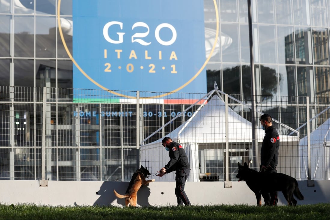 Police officers inspect the area with dogs trained to detect explosives, outside the La Nuvola convention centre, ahead of the Group of 20 summit in Rome, on October 27. Photo: Reuters