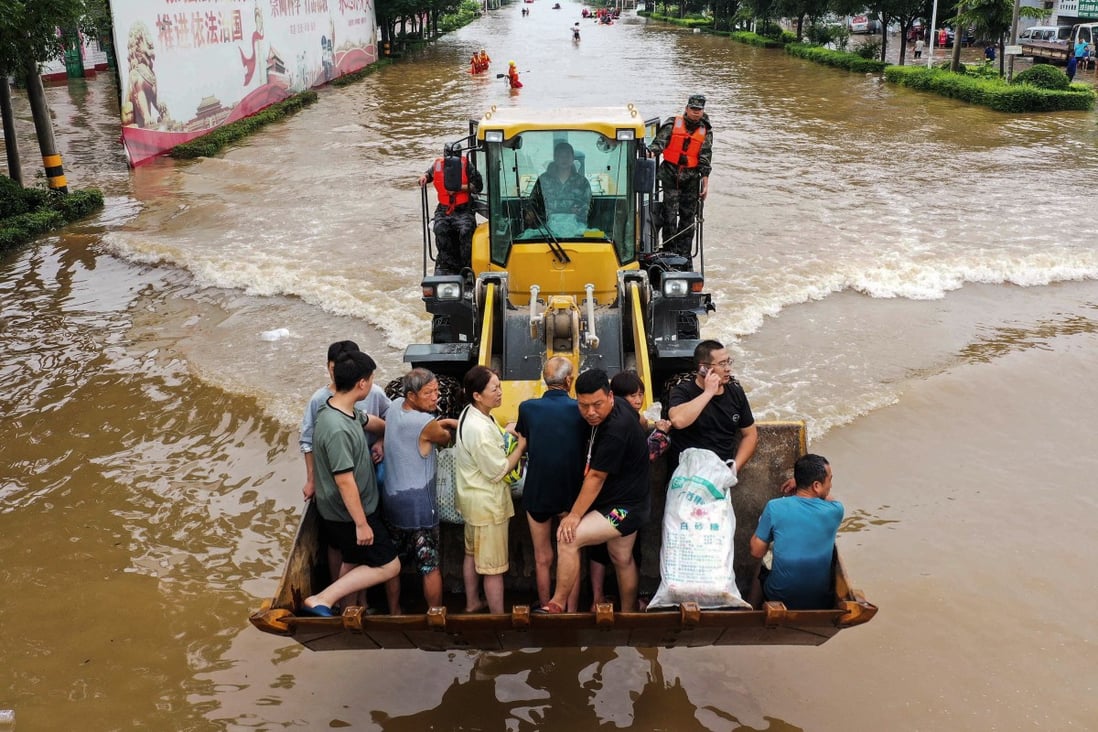 Residents being evacuated from flood-hit Xinxiang in China’s Henan province. Photo: AFP