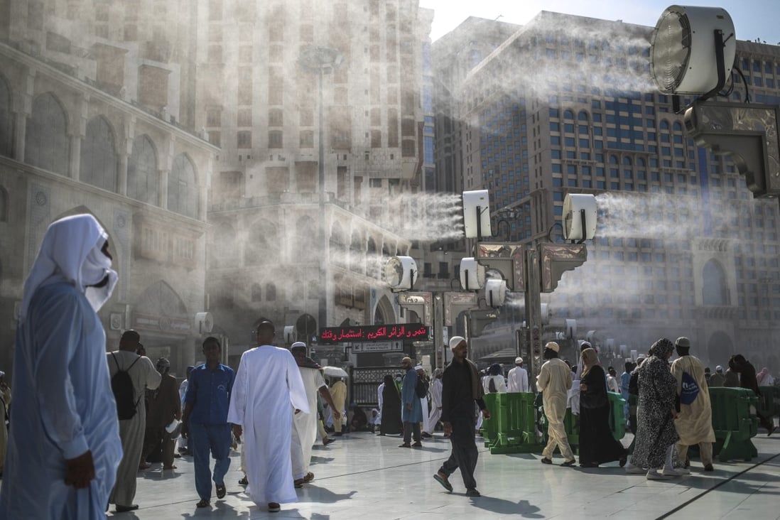 Water is sprayed over Muslim pilgrims to cool them down during the afternoon heat as they walk outside the Grand Mosque in the holy city of Mecca, Saudi Arabia. With a climate that is already among the hottest on earth, Saudi Arabia has reason to fight global heating. Photo: AP