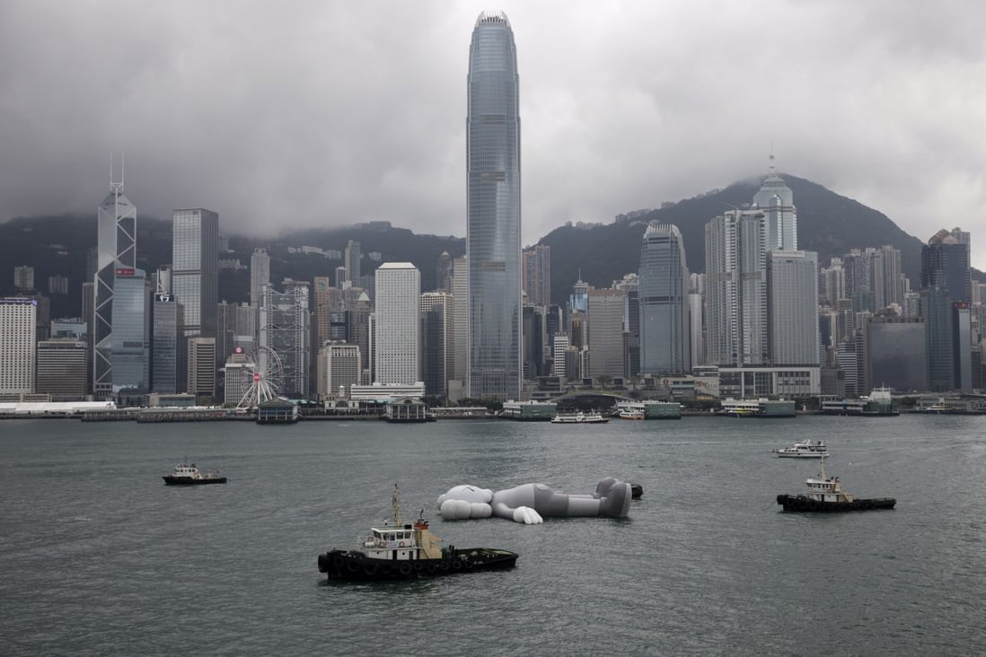 Tugs tow the 37-metre-long Companion inflatable sculpture through Hong Kong’s Victoria Harbour in March 2019 for a Kaws: Holiday event in the city. An injunction was served at the unveiling of a similar display of Companion in Singapore. Photo: EPA