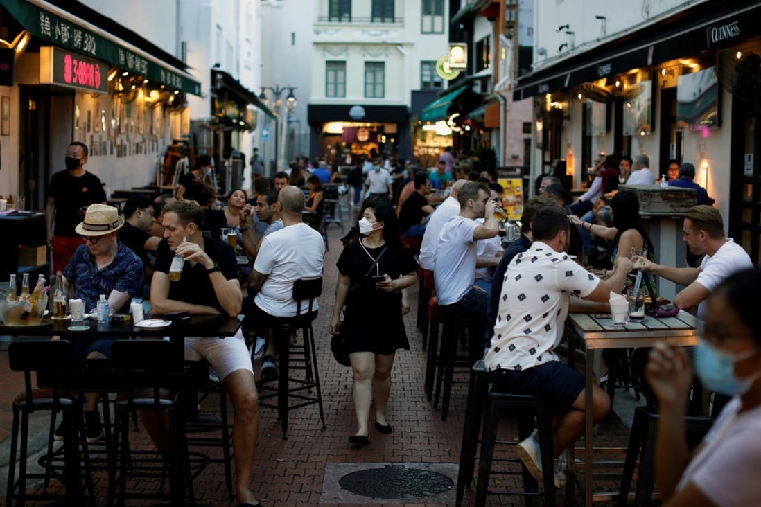 People dine in the Boat Quay nightlife area in Singapore on September 24. The country has reopened its borders to vaccinated international travellers. Photo: Reuters