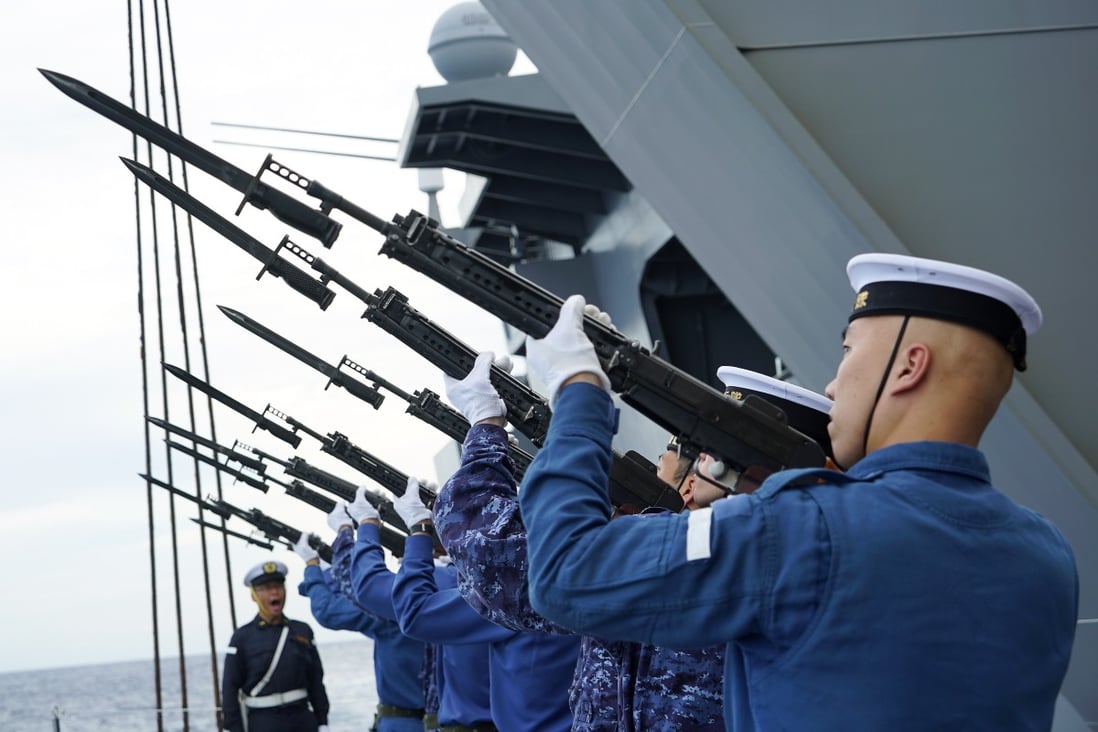 Members of the Japanese Maritime Self-Defence Force helicopter carrier JS Izumo rehearse a memorial ceremony for those who died during World War II. Photo: AP