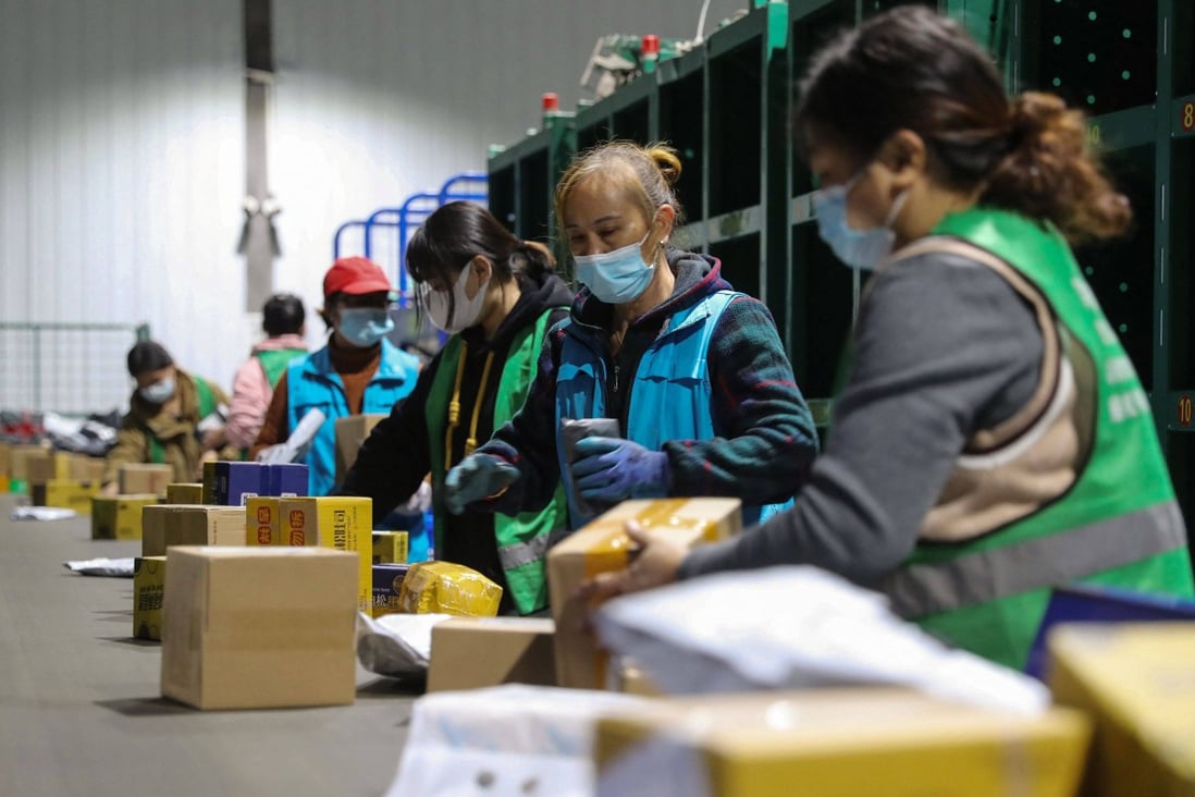 Workers sort packages at a logistics firm in Hunan province, China. Photo: AFP