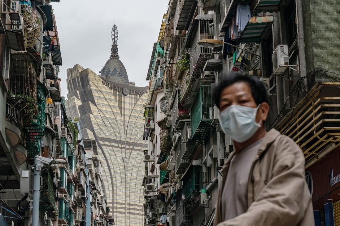 A man wearing a mask crosses a street in front of Grand Lisboa Hotel in Macau on February 5, 2020. Photo: Getty Images