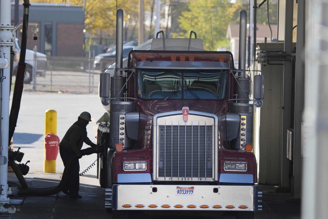 A trucker puts fuel into his truck in Salt Lake City, Utah. US President Joe Biden has  ordered the release of 50 million barrels of oil from US strategic reserves in a coordinated attempt with other countries to tamp down soaring fuel prices. Photo: AFP