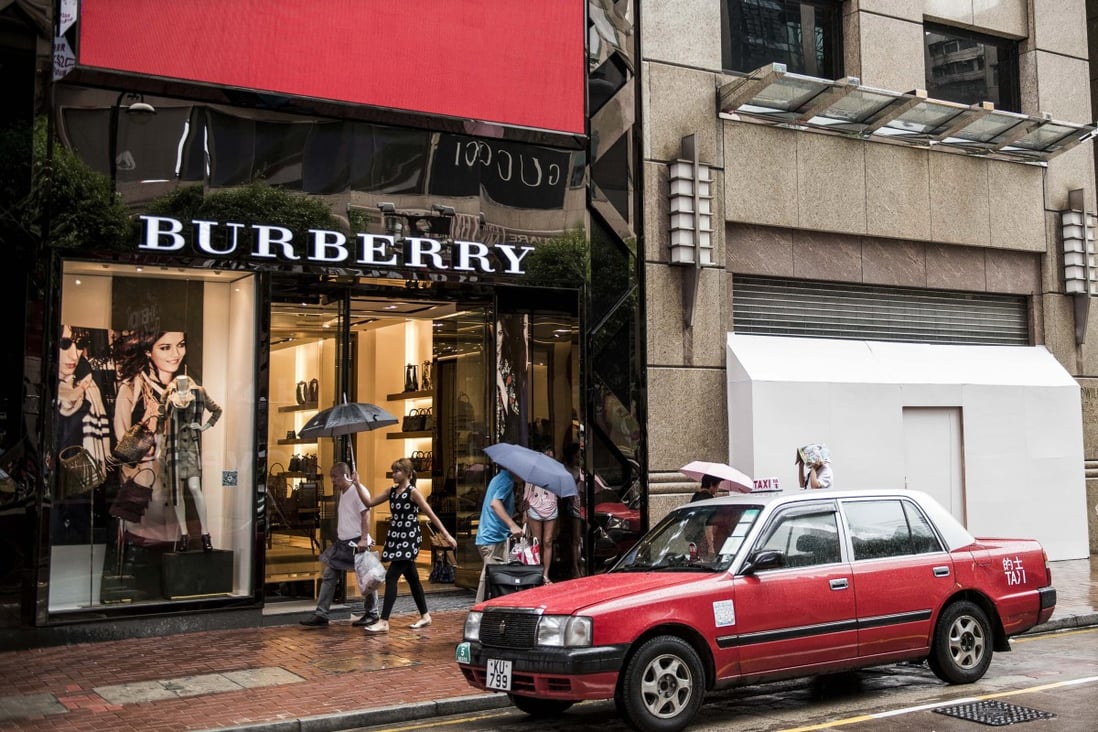 Pedestrians walk past Burberry’s flagship store on Russell Street in Hong Kong’s Causeway Bay shopping district. Russell Street once had the highest retail rents in the world. Photo: Bloomberg