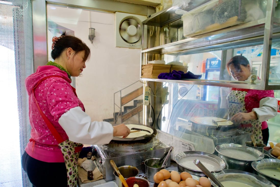 Zhang Lihua prepares Shandong jianbing at a small restaurant in the eastern suburbs of Beijing. Small businesses make up almost 90 per cent of global firms and the majority of employment, but their access to global credit and markets will remain limited without greater interoperability in trade finance systems. Photo: Tom Wang