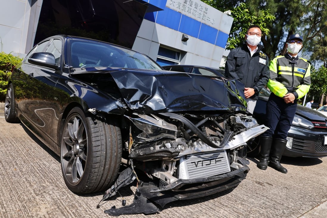 Chief Inspector Kwan Chun-hin (second from right) of the New Territories North traffic unit with one of the vehicles involved in the crash. Photo: Dickson Lee
