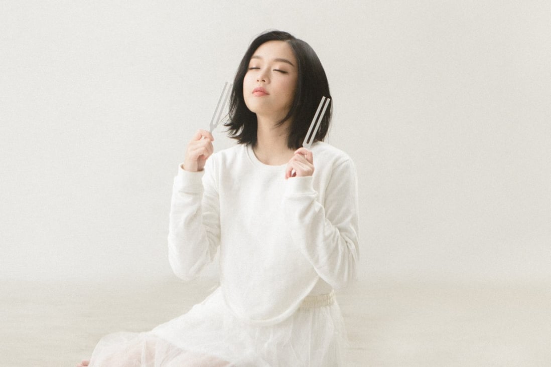 Jocelyn Chan Ming-hei shows off the tuning forks that feature in her chart-topping Canto-pop song Sound of Silence. The vibrations they give out are a form of music therapy to help listeners relieve stress and sleep better.