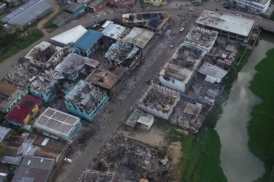 An aerial view shows burned-out buildings in Honiara’s Chinatown on November 27 after calm returned to the Solomon Islands’ capital following days of rioting that left at least three dead and reduced sections of the city to smouldering ruins. Photo: AFP