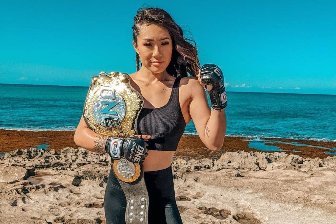 Angela Lee poses with her ONE Championship atomweight title on a beach in her native Hawaii. Photo: Instagram/@angelaleemma