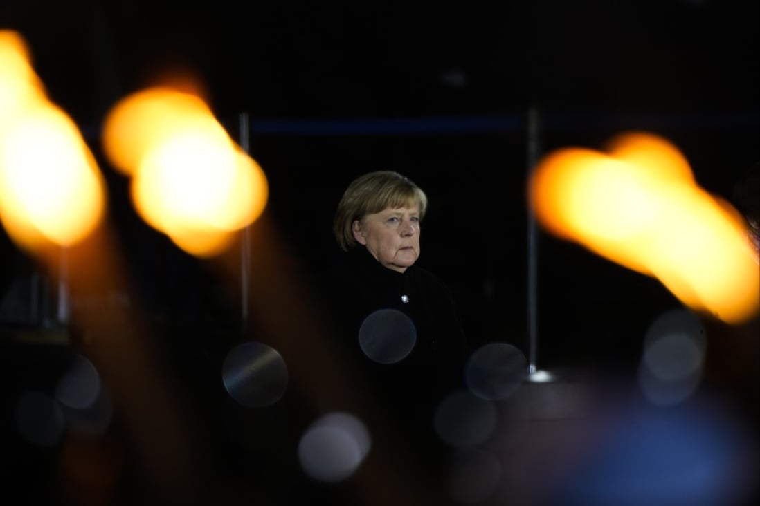 Chancellor Angela Merkel attends in a grand tattoo ceremony to mark the farewell of her chancellorship in Berlin. Photo: AP